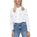 White button-up shirt with red polka dots paired with blue jeans by Only for Women