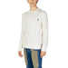 White cable-knit sweater featuring a small embroidered logo from US Polo Assn