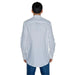 White Tommy Hilfiger long-sleeved button-up shirt worn by a man facing away