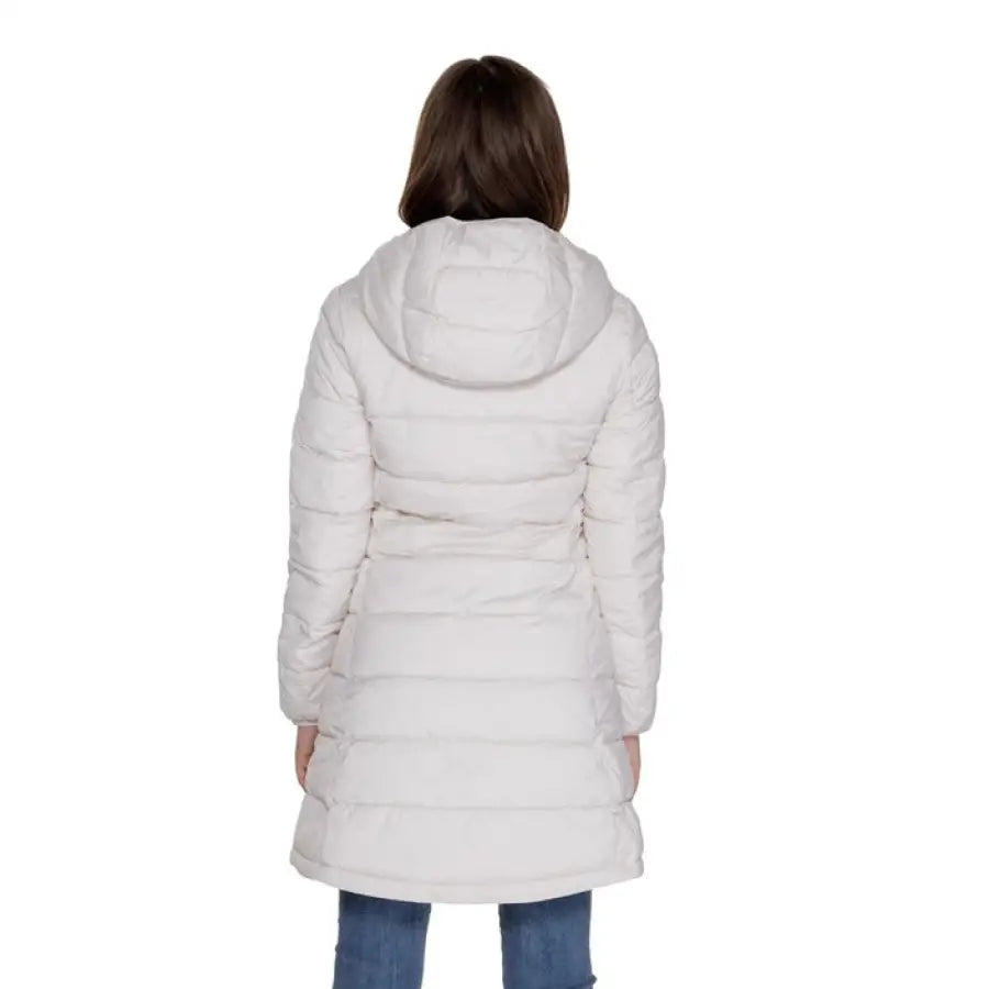 Back view of white puffy winter coat with hood on person in jeans - Guess Women Jacket