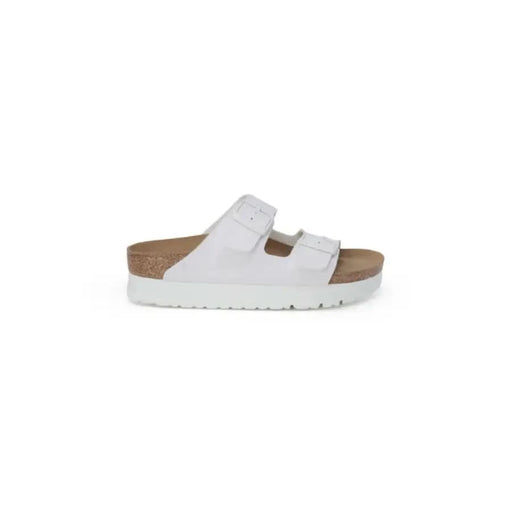 White Birkenstock women’s sandal with two adjustable straps and a platform sole