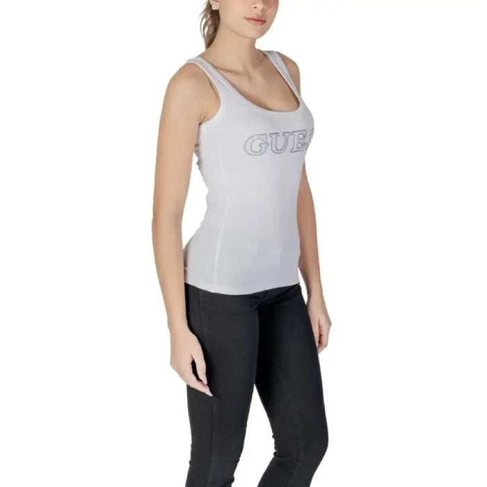 White sleeveless athletic tank top featuring GUESS text across the chest for women