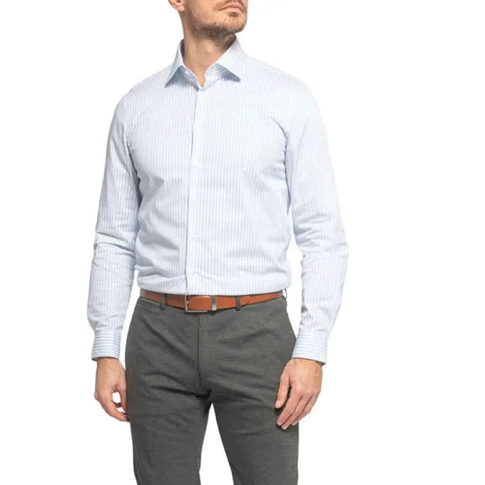 Calvin Klein Men Shirt white striped dress shirt paired with gray pants and brown belt