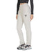 White sweatpants featuring a triangular logo on the thigh from Guess Active Women Trousers