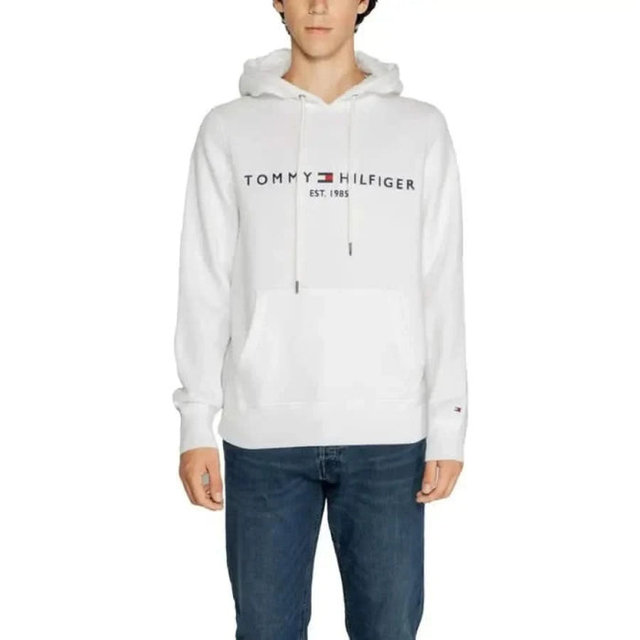 White Tommy Hilfiger hoodie with brand name and EST 1985 on front, featured in men sweatshirts