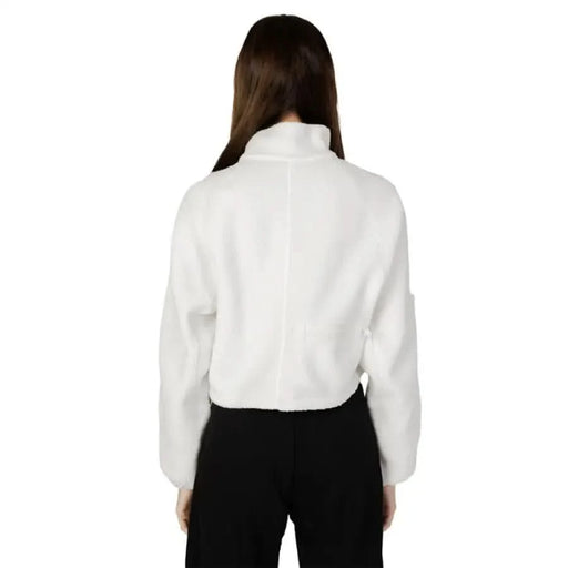 Calvin Klein Sport women’s white turtleneck sweater worn by person with long brown hair, rear view