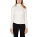 White turtleneck sweater worn by a woman with long blonde hair from Guess Knitwear