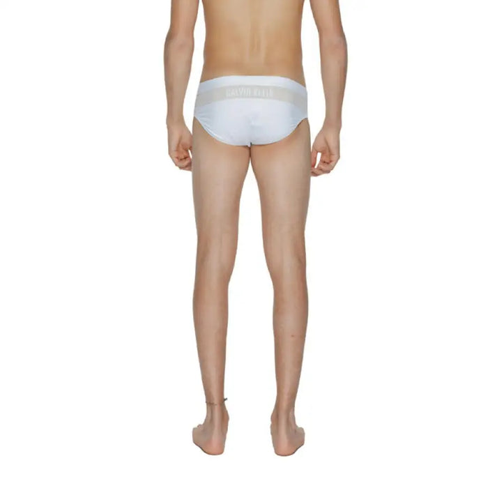 Calvin Klein Men Swimwear white briefs displayed on a mannequin’s lower body