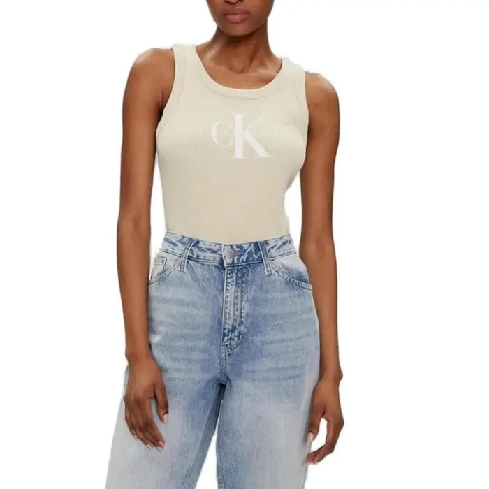 Woman in beige Calvin Klein tank top and light blue jeans - Calvin Klein Jeans undershirt