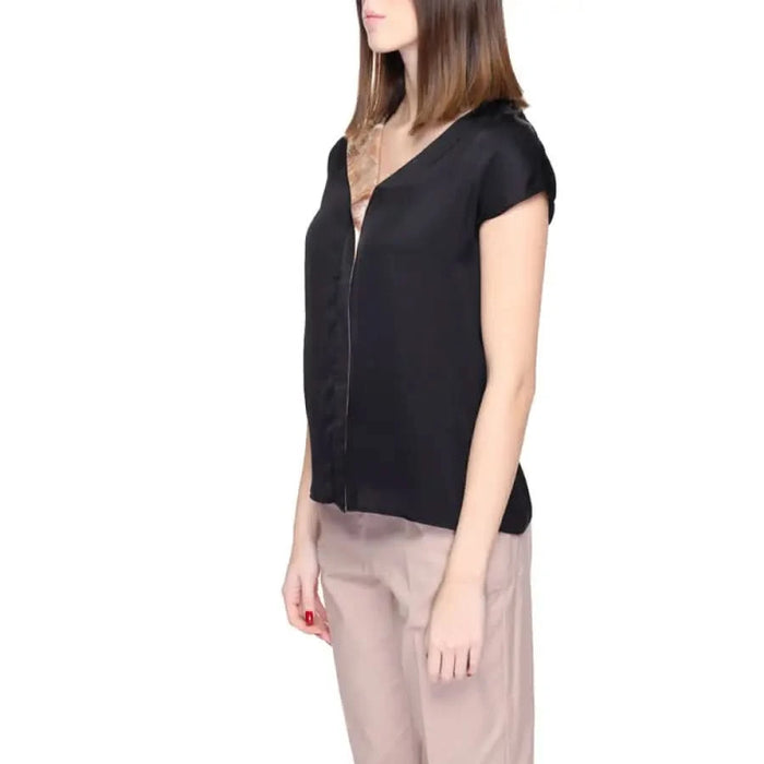 Woman in Alviero Martini Prima Classe black top and beige pants - Women Blouse