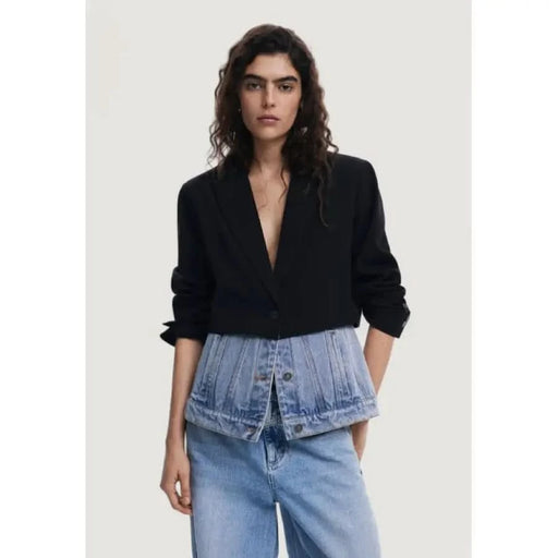 Woman in a black blazer and denim waist detail from Desigual Women’s Collection