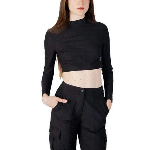 Woman in black crop top and high-waisted cargo pants - Calvin Klein Jeans Women’s T-Shirt