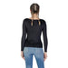 Woman in black long-sleeved shirt and blue jeans wearing Guess Women Black Long Round Neck Sweater