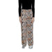 Woman in Jacqueline De Yong black top and patterned Yong women trousers