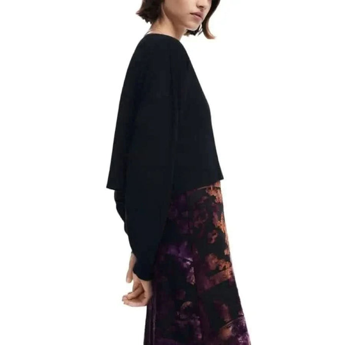 Woman in a black sweater over a floral dress from Desigual Women Dress collection