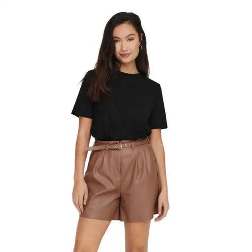 Woman in black t-shirt and brown leather shorts from Only - Only Women T-Shirt collection