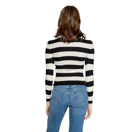 Woman in black and white striped top and blue jeans, showcasing Jacqueline De Yong Knitwear