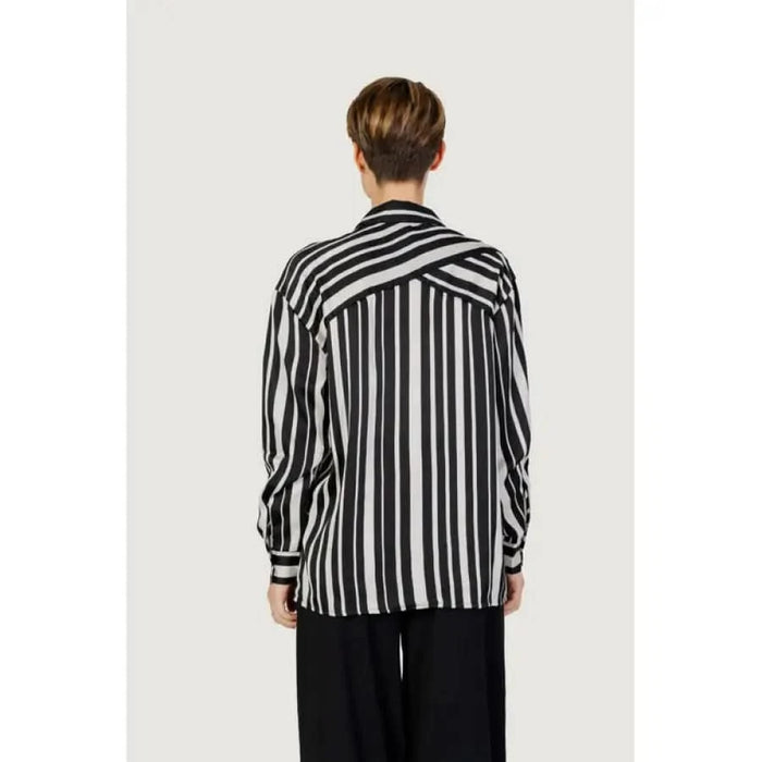 Woman in Only black and white striped women shirt showcasing urban city fashion