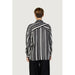 Woman in Only black and white striped women shirt showcasing urban city fashion