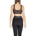 Woman in black workout leggings and matching sports bra from Calvin Klein Sport