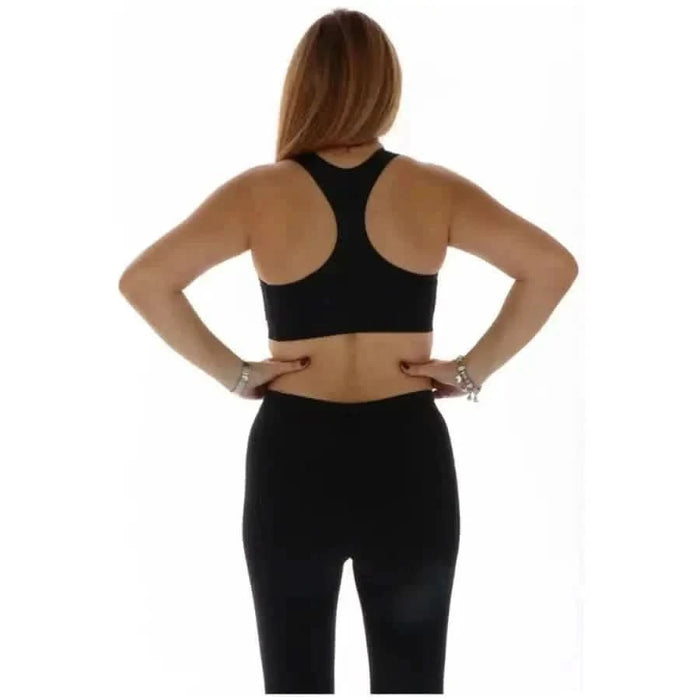 Woman in black workout attire, back view, wearing the Nike Women Top