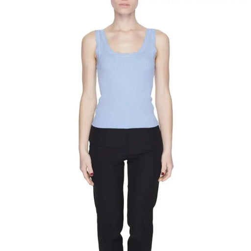 Woman in blue top, black pants showcasing Jacqueline De Yong urban style clothing