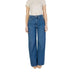 Woman in blue wide-leg jeans and beige t-shirt featuring Women’s Blue Plain Cotton Jeans