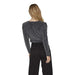 Woman in gray long-sleeved Vila Clothes T-shirt and black pants viewed from behind