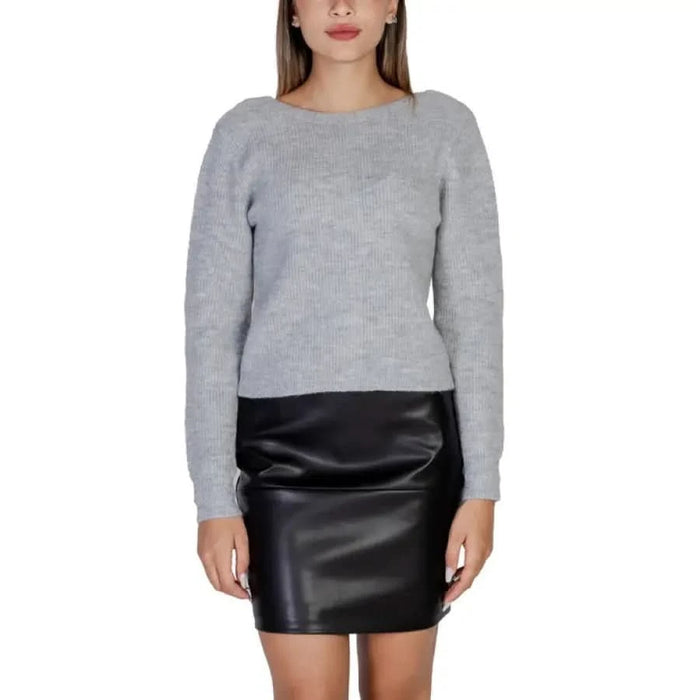 Woman in gray sweater and black leather mini skirt from Morgan De Toi Knitwear