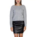 Woman in gray sweater and black leather mini skirt from Morgan De Toi Knitwear