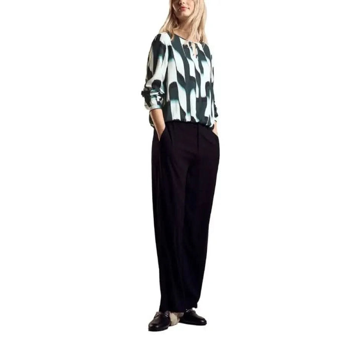 Woman in a patterned blouse and wide-leg black trousers from Street One Women Shirt