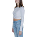 Woman in white cropped long-sleeve top and light blue jeans from Tommy Hilfiger Women T-Shirt