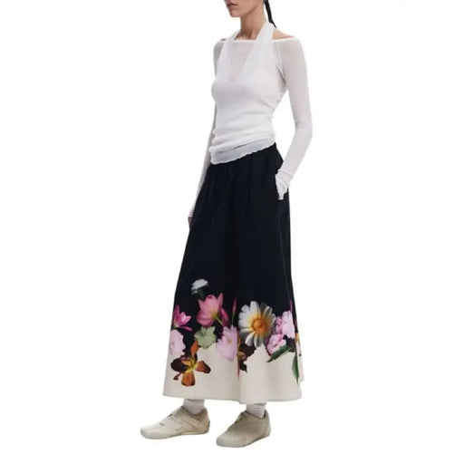 Woman in white halter top and floral-print pants showcasing Desigual Women’s Floral Cotton Skirt