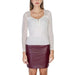 Woman in white lace-sleeved top and burgundy leather mini skirt from Morgan De Toi Knitwear