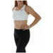 Woman in white Nike sports bra and black leggings from Nike Women Top collection