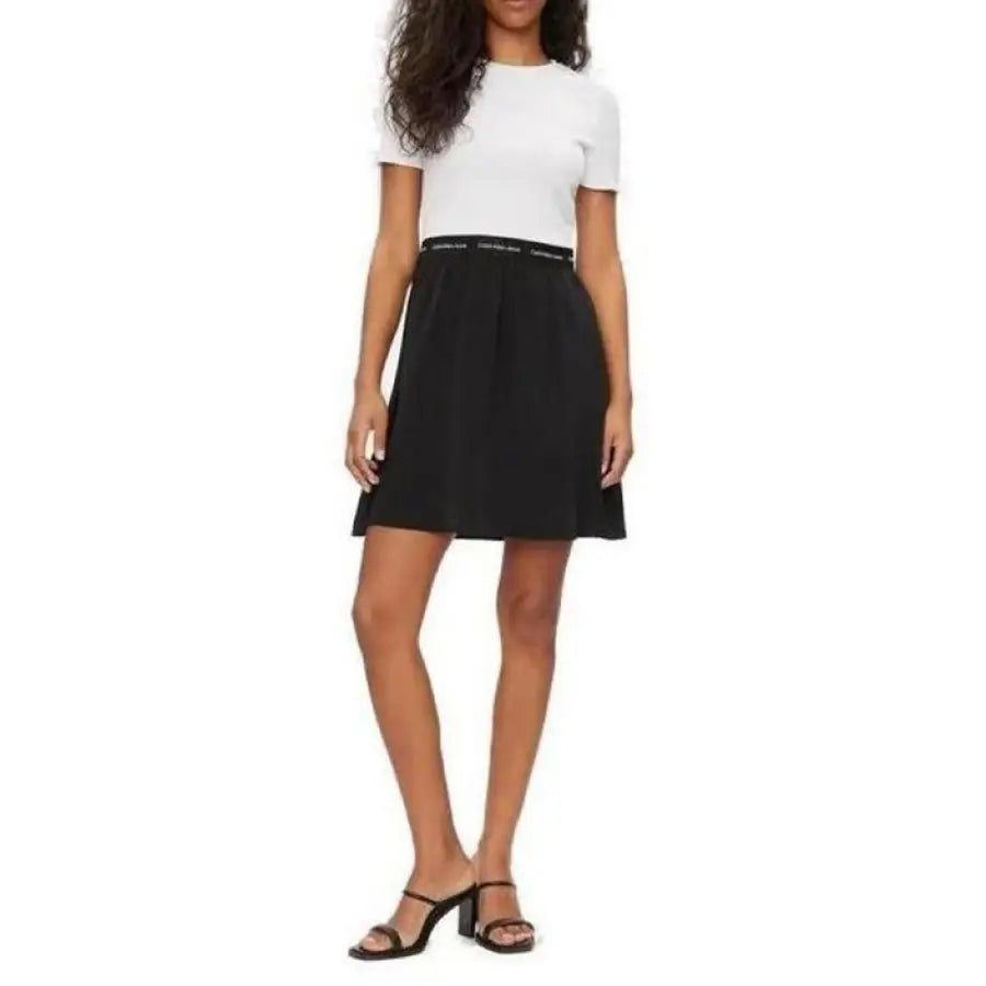 Calvin Klein Jeans Women Dress: Woman in white top, black skirt, and sandals