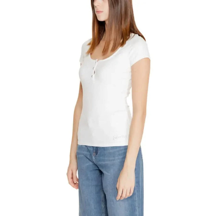 Woman in a white short-sleeved shirt and blue jeans from Guess - Guess Women Knitwear collection