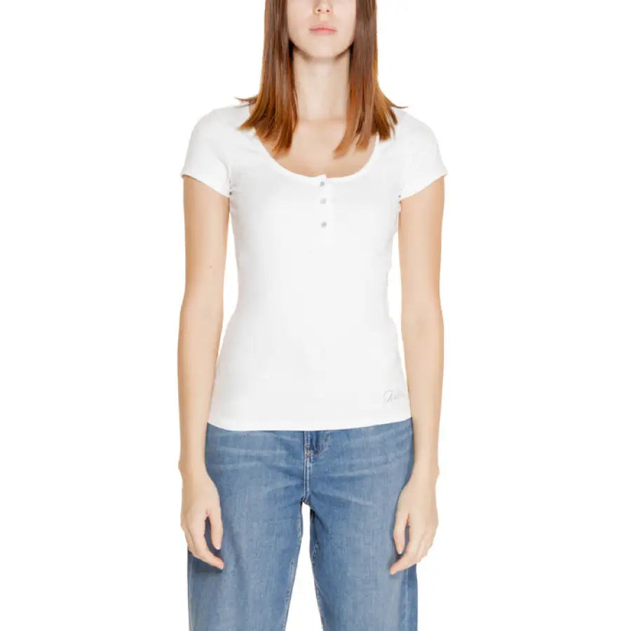 Woman in white short-sleeved shirt and blue jeans from Guess Women Knitwear Collection