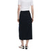 Woman in white t-shirt and navy Desigual skirt with zip and button closure