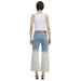 Woman in a white tank top and dip-dyed jeans from Desigual Women’s Floral Blue Jeans