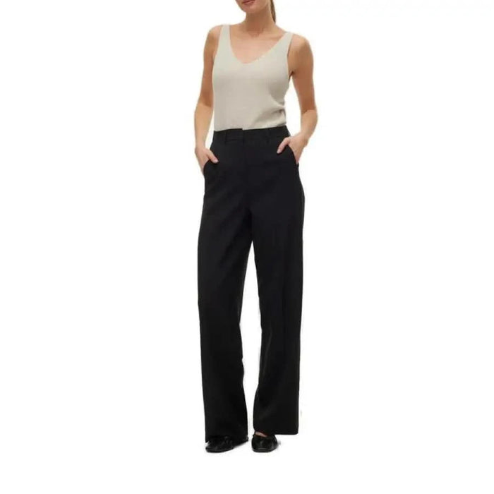 Vero Moda woman in urban style clothing white tank top and black pants