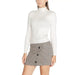 Woman in white turtleneck sweater and plaid mini skirt from Jacqueline De Yong Knitwear