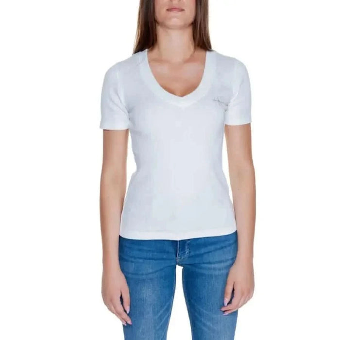 Woman in white V-neck T-shirt and blue jeans from Calvin Klein Jeans Women Collection