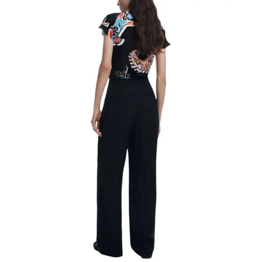 Woman wearing Desigual Women’s Black Print Short Jumpsuit with patterned top