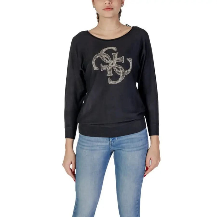 Woman wearing a black long-sleeved sweatshirt from Guess Women’s White Knit Sweater line