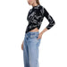 Desigual Women’s Black Printed Knit Sweater with Light Blue Jeans for a stylish look