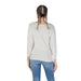 Woman wearing Guess Women’s White Knit Sweater Round Neck with jeans