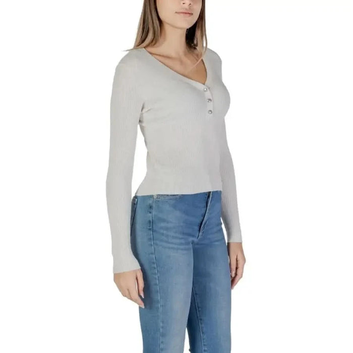 Woman wearing Guess Women’s Knitwear White V-Neck Sweater with jeans