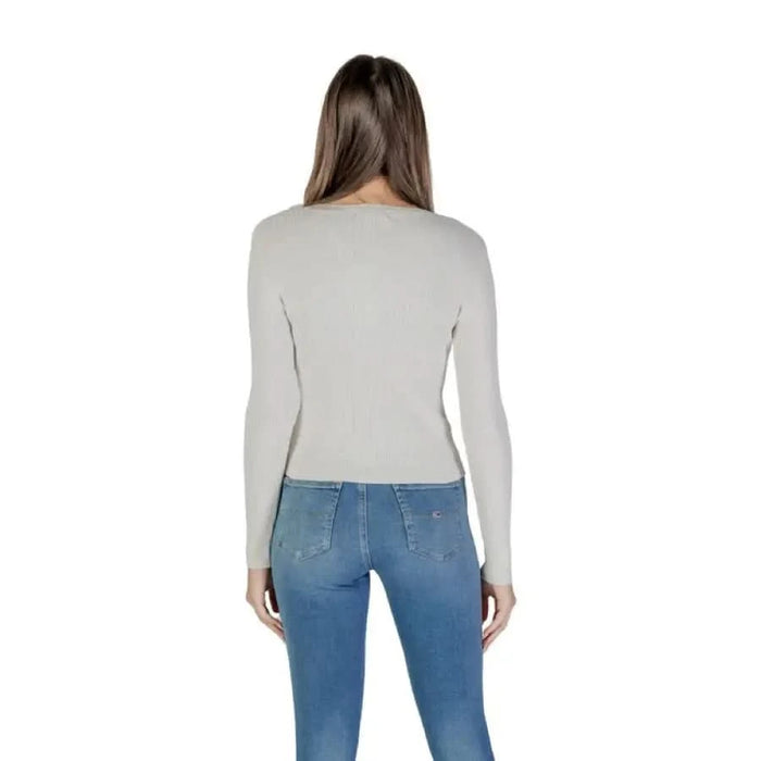 Woman wearing Guess Women’s Knitwear White V-Neck Sweater with jeans