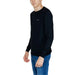 Young boy modeling Guess Men Knitwear in a stylish black sweater